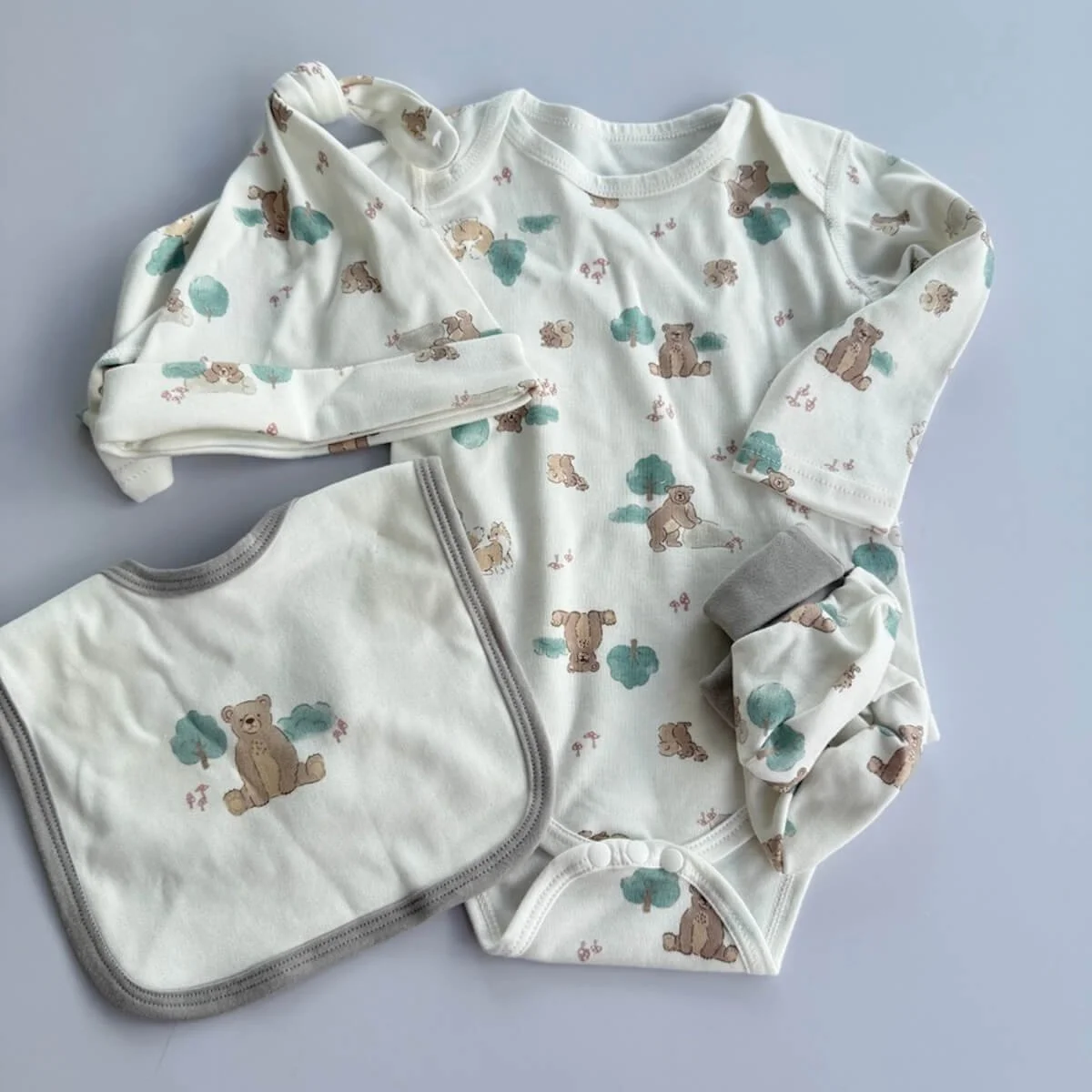 Animal-themed baby clothing set including top and pants, sleeveless bodysuit, hat, bib, and booties from the Sweet Dreams Baby Gift