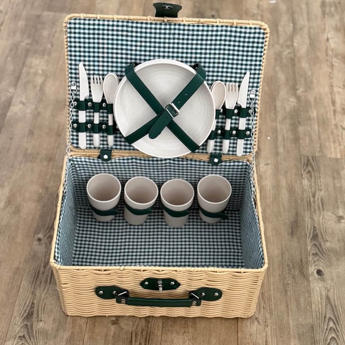 Empty plastic wicker picnic basket for four, 40 x 28 x 21 cm, with moss-green picnic blanket folded inside