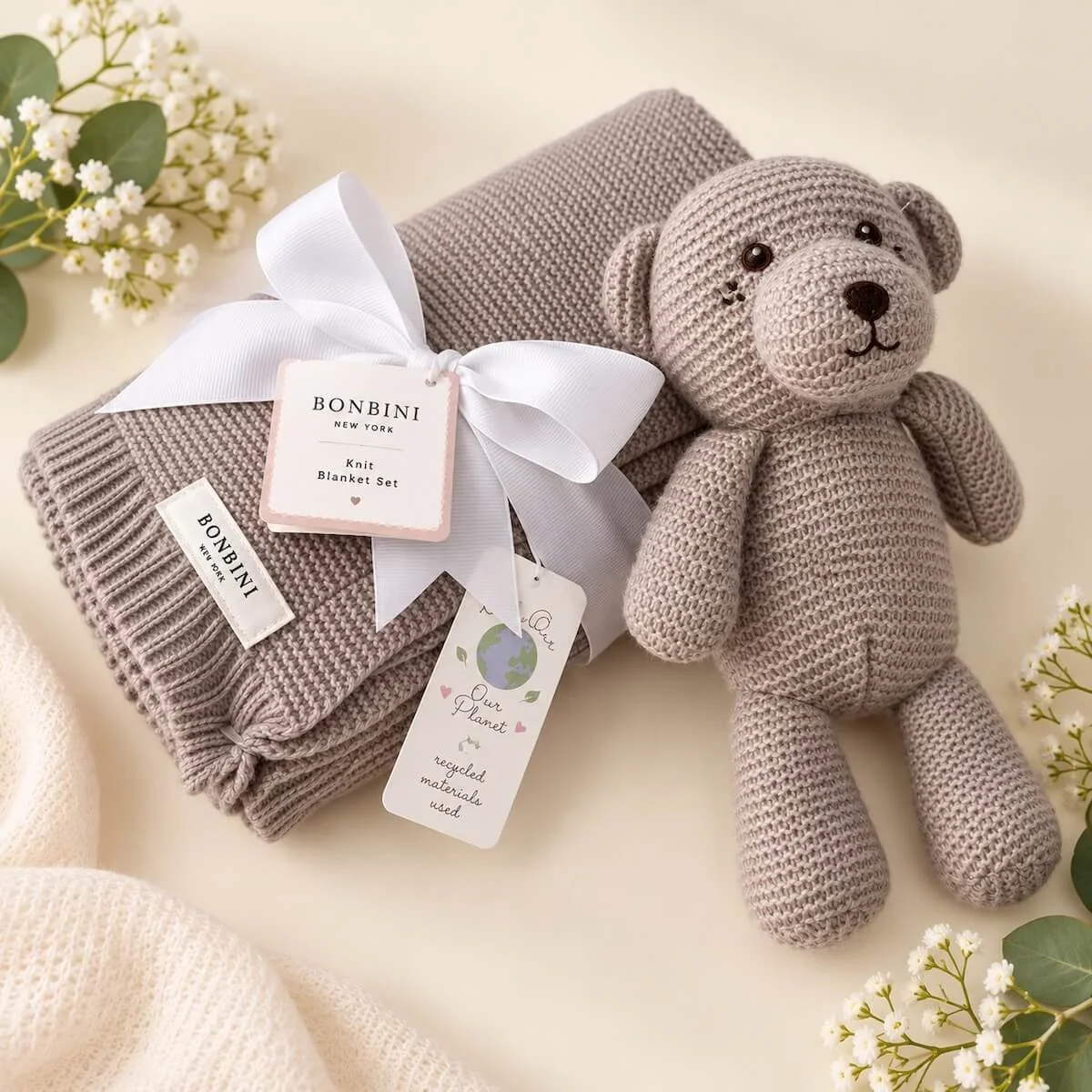 Soft taupe BONBINI knitted baby blanket with matching teddy bear, beautifully presented with a white ribbon.