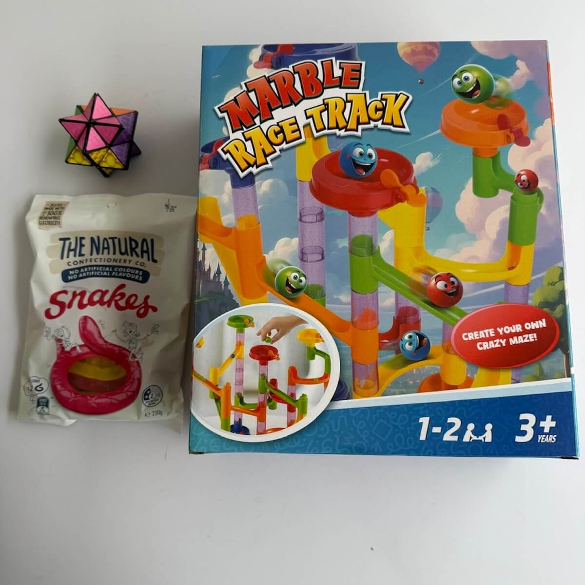 Marble race track game andMini hand puzzle and snake lollies included in the Little Boy Blue Gift Hamper