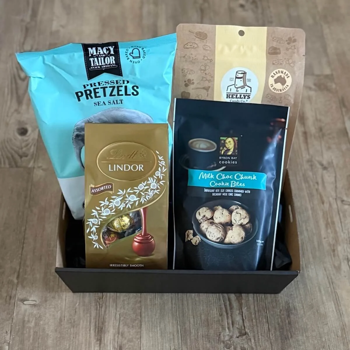 Just Because Treat Box featuring flat pretzels, Lindt chocolate and Kelly’s peanut brittle or chocolate fudge, beautifully presented