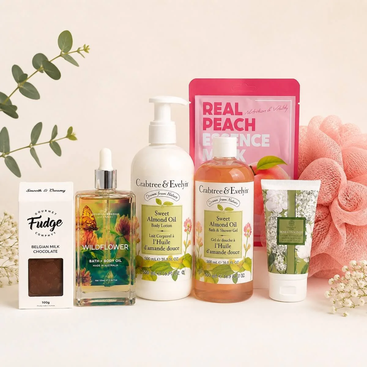 Items displayed from gift hamper, Evelyn and Crabtree body lotion and shower Gel. Also includes  body oil, hand cream, a face mask, washer and gourmet fudge.