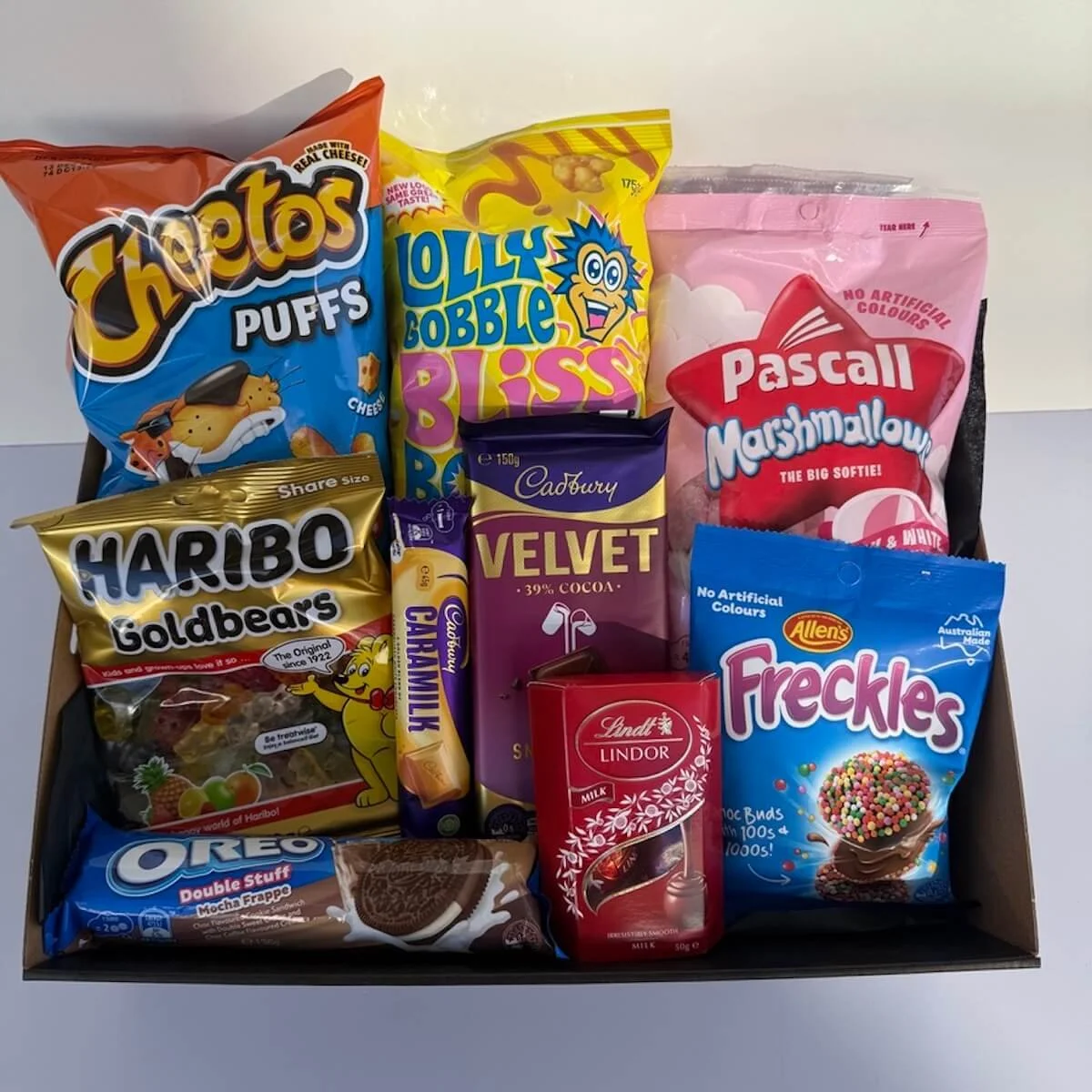 Lollie love gift with assorted sweets, mashmellows, freckles, chocolates, oreos, cheetos, lolly gobbles bliss bombs and more in a gift tray