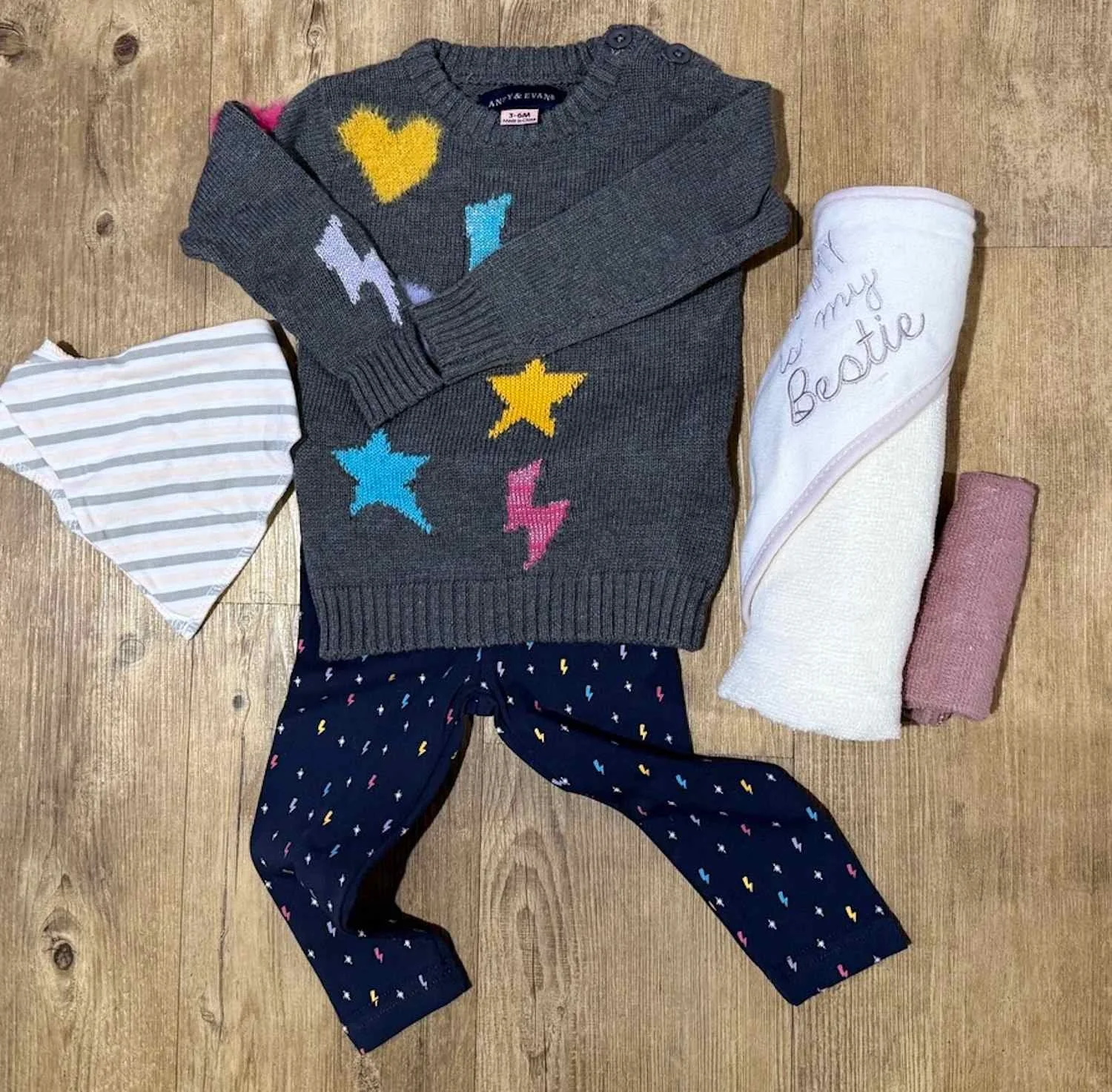 Baby clothing. A knit jumper and pair of pants set, a bandana bib and hooded towel and washer.