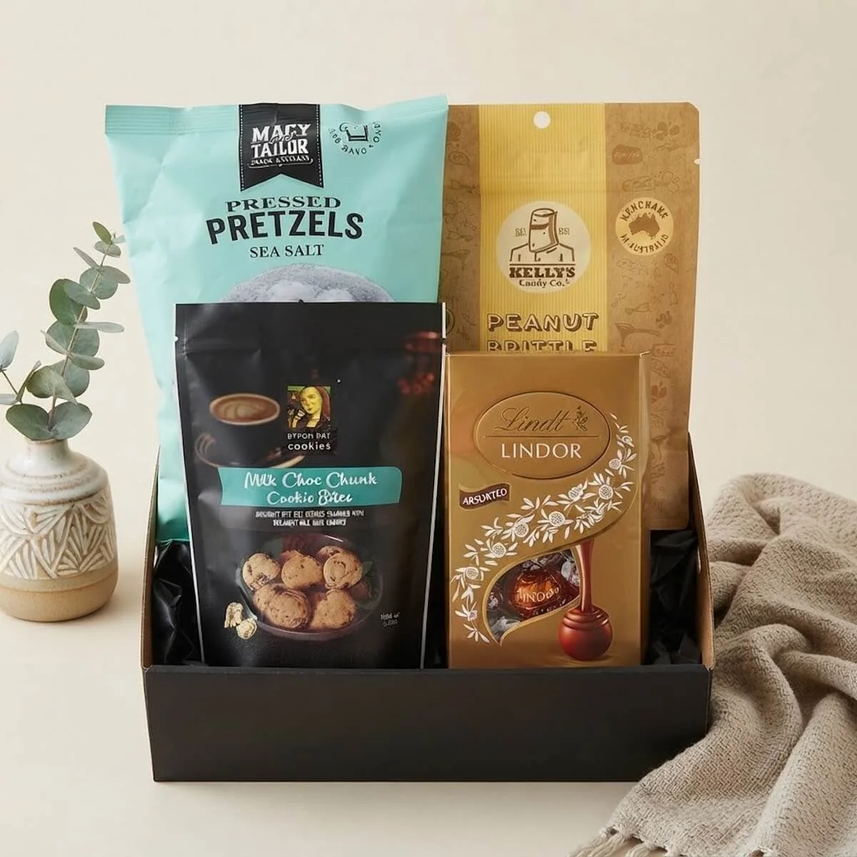 Just Because Treat Box featuring flat pretzels, Lindt chocolate and Kelly’s peanut brittle or chocolate fudge, beautifully presented for gold coast delivery.
