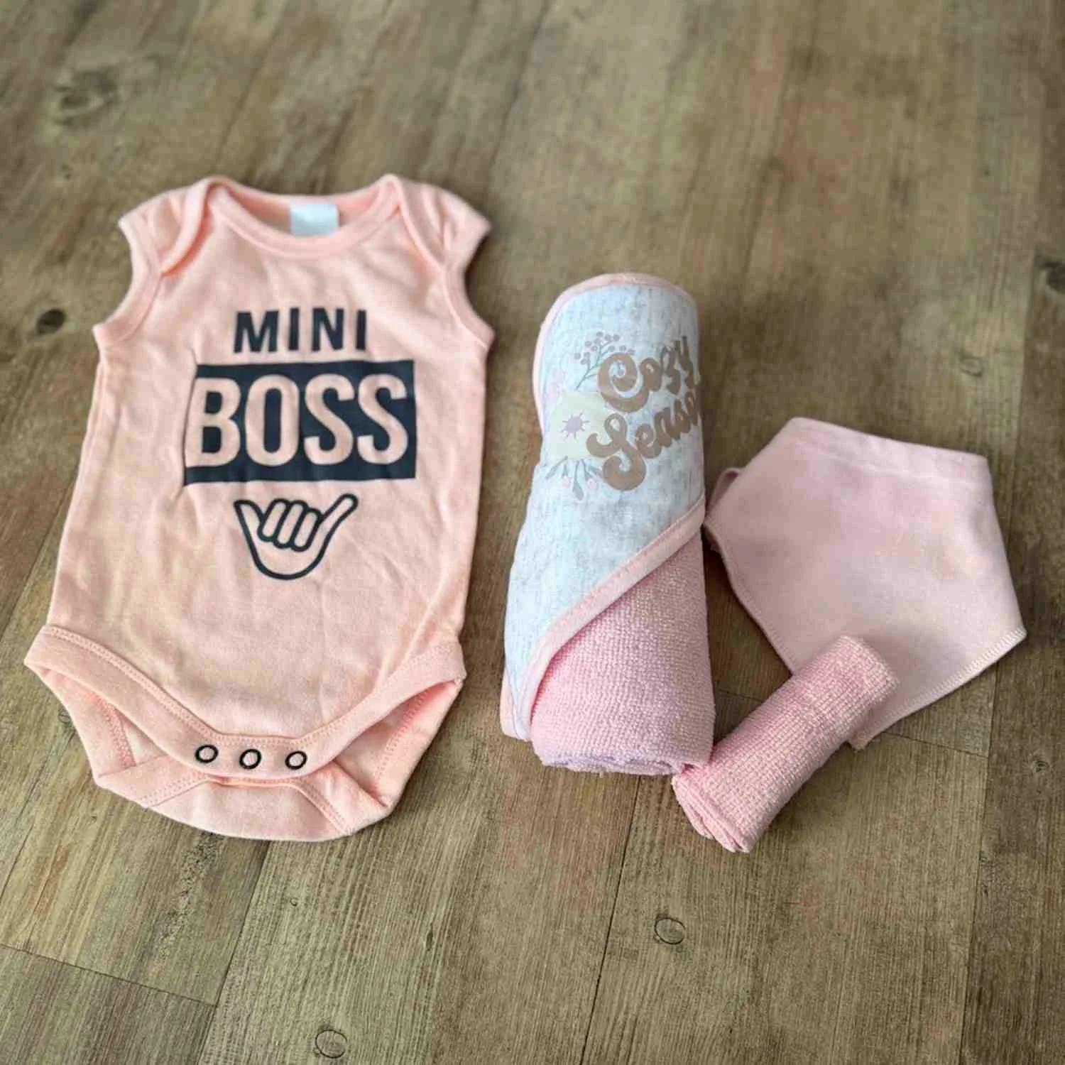 Body suit with the Mini boss theme, A hooded towel and washer and bandana bib included in Baby Gift Box.