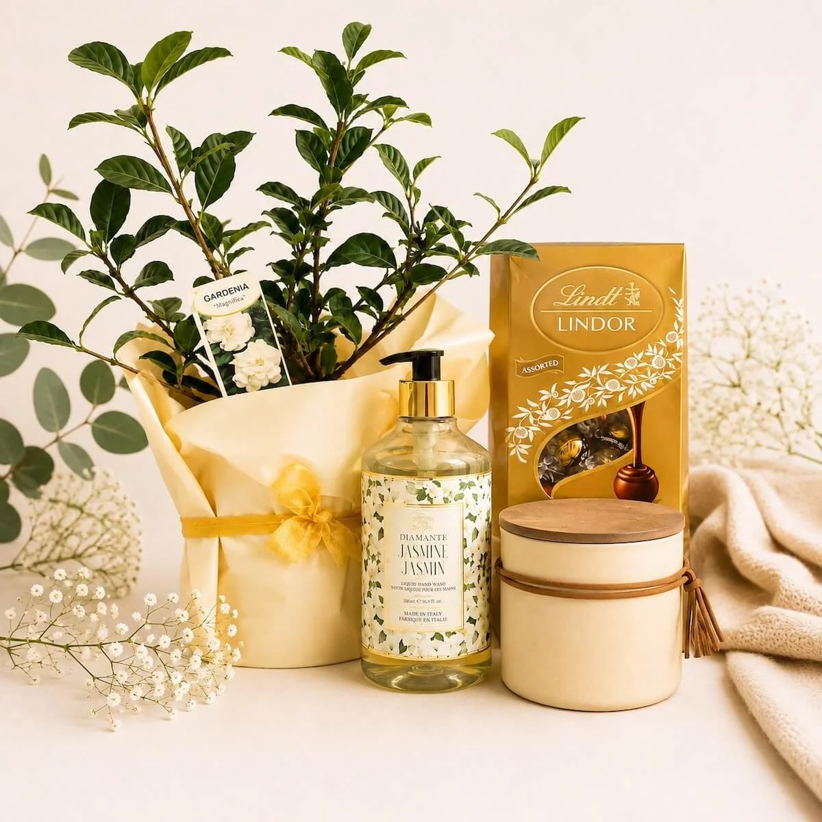 Gardeniagift hamper items - Gardenia plant, chocolates, candle and hand wash.