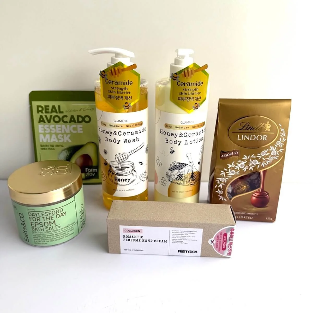 Glamfox body wash and lotion, Epsom bath salts, collagen hand cream, avocado face mask and Lindt chocolates displayed together