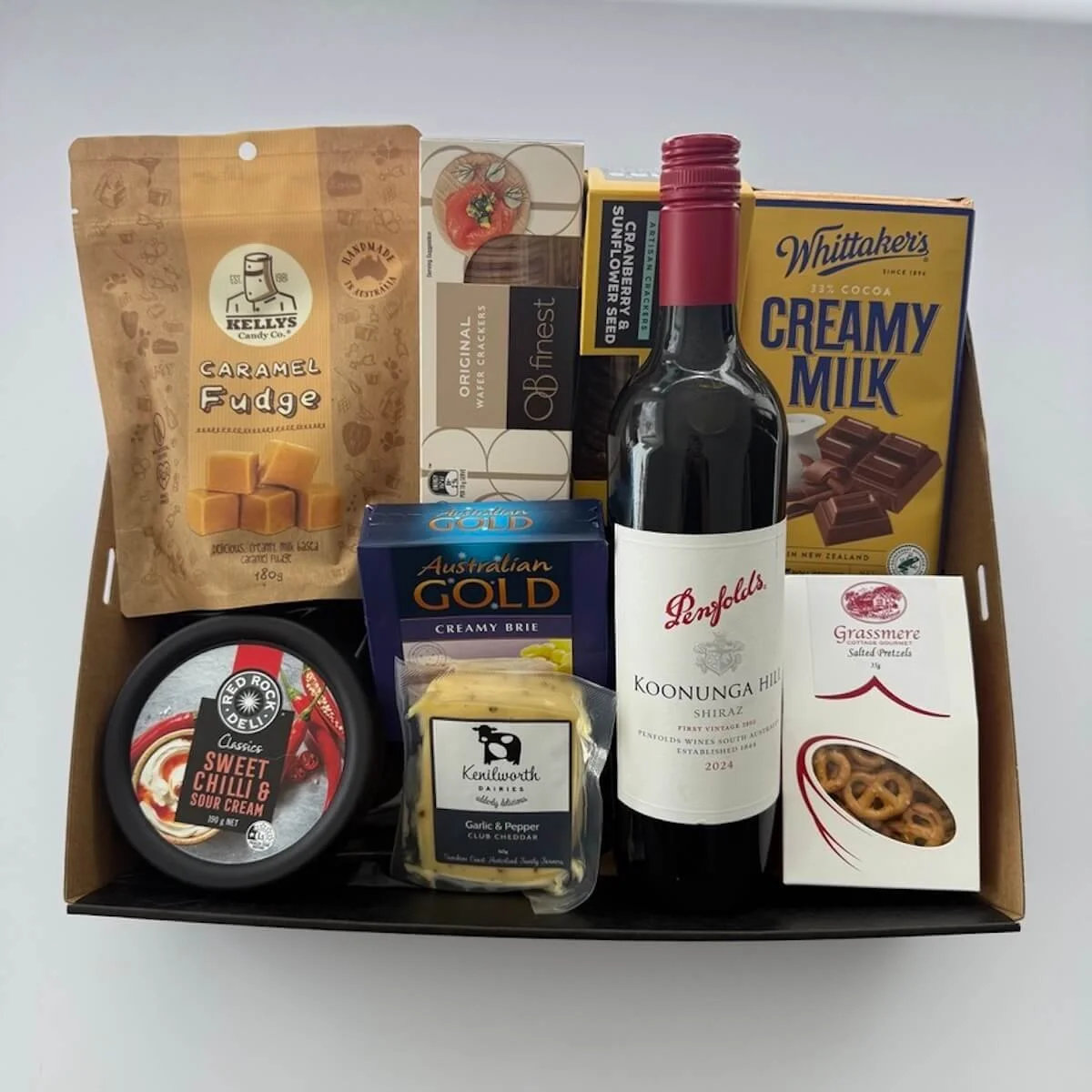 Popular wine and cheese gift with 700 ml wine, cheeses, crackers, dip, fudge, chocolates for deivery on the gold coast.