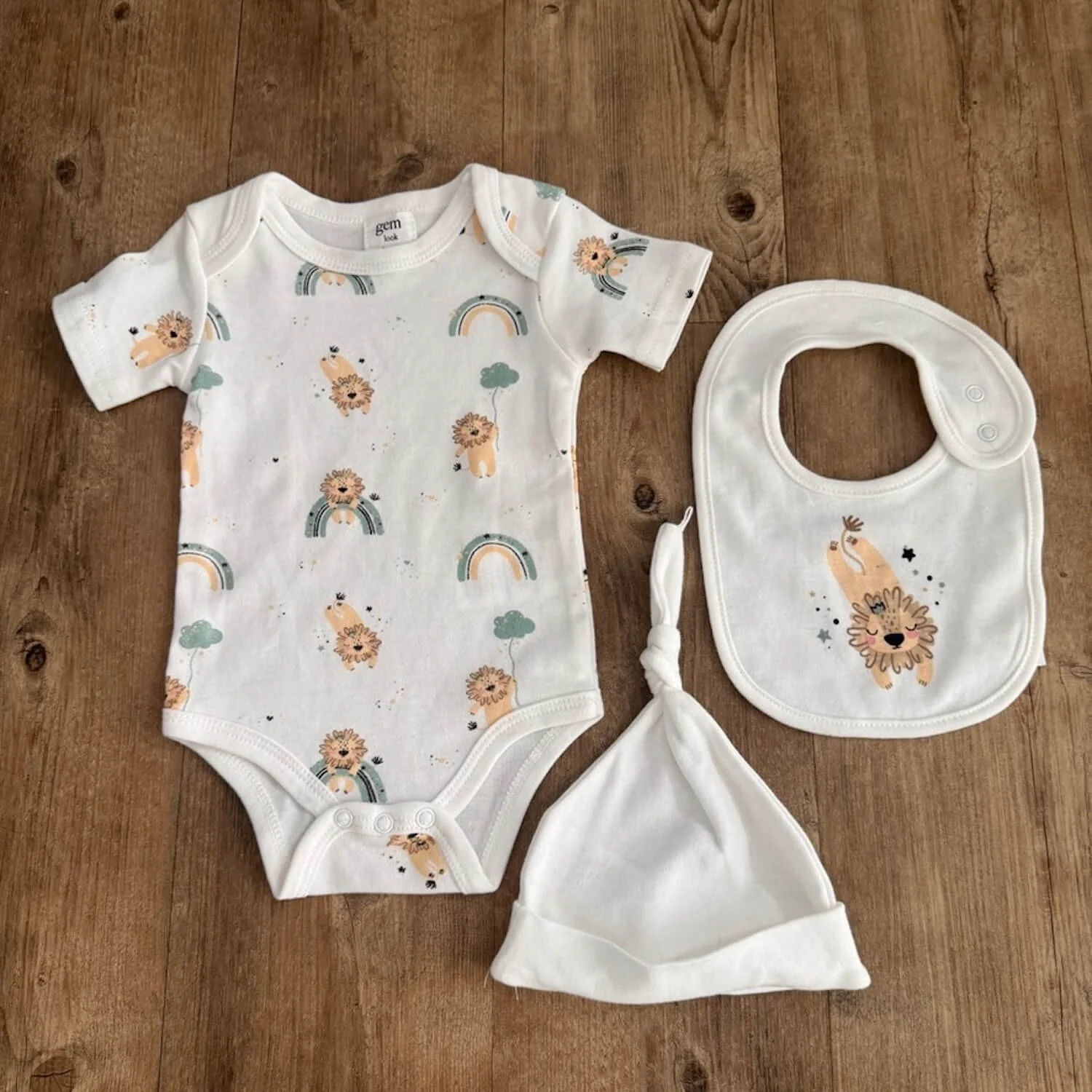 Three-piece animal and rainbow-themed baby clothing set including top, pants, and bodysuit from the Love You to the Moon & Back Baby Gift Box