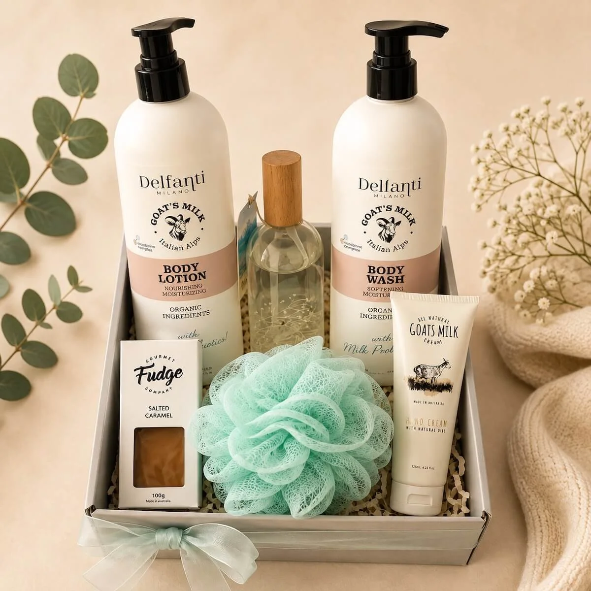 Luxury ladies pamper gift hamper featuring Delfanti Milano Goats Milk skincare, botanical room spray, and gourmet fudge. High-end spa gift set in a ribbon-tied box with cellophane wrapping.
