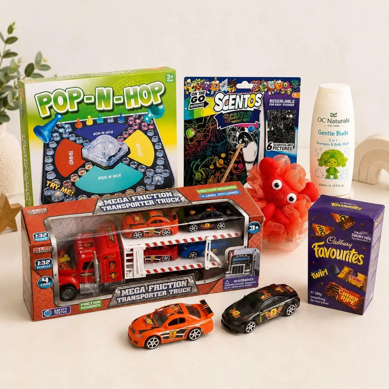 Zac gift hamper hamper items Transporter Truck toy, Pop-n-hop game, Scratch art kit and Favourites chocolates in a gift tray.