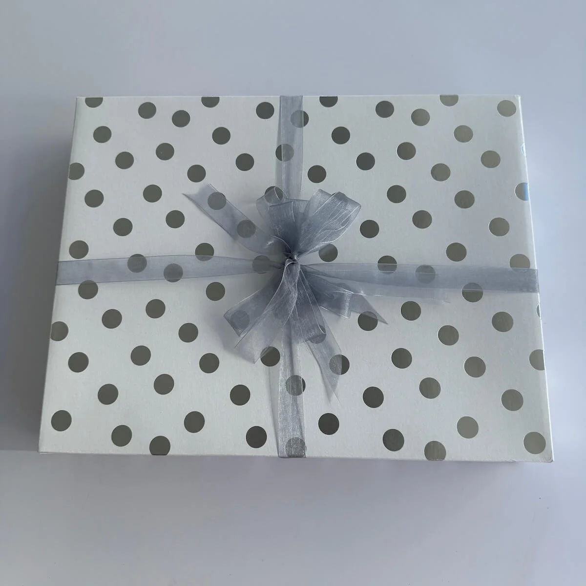 Love You to the Moon & Back Baby Gift Box in a closed wooden gift box, tied with ribbon and bow, ready to gift