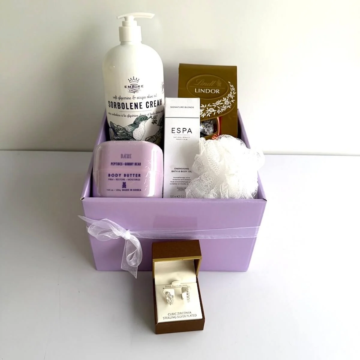 Body & Soul Ladies Gift Hamper with ESPA body oil, body butter, Lindt chocolates and cubic zirconia earrings in a luxury gift box.