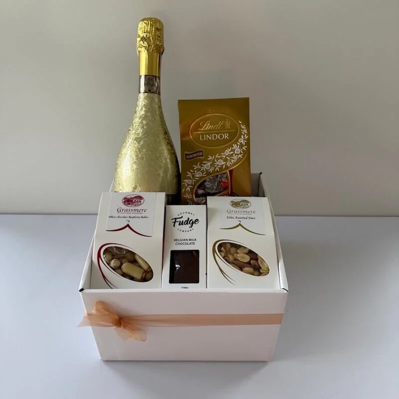 Gold & Gourmet Hamper featuring Sensi Prosecco Gold sparkling wine, Lindt chocolates, raspberry chocolate bullets, gourmet fudge, and assorted nuts, beautifully presented as a luxury celebration gift hamper.