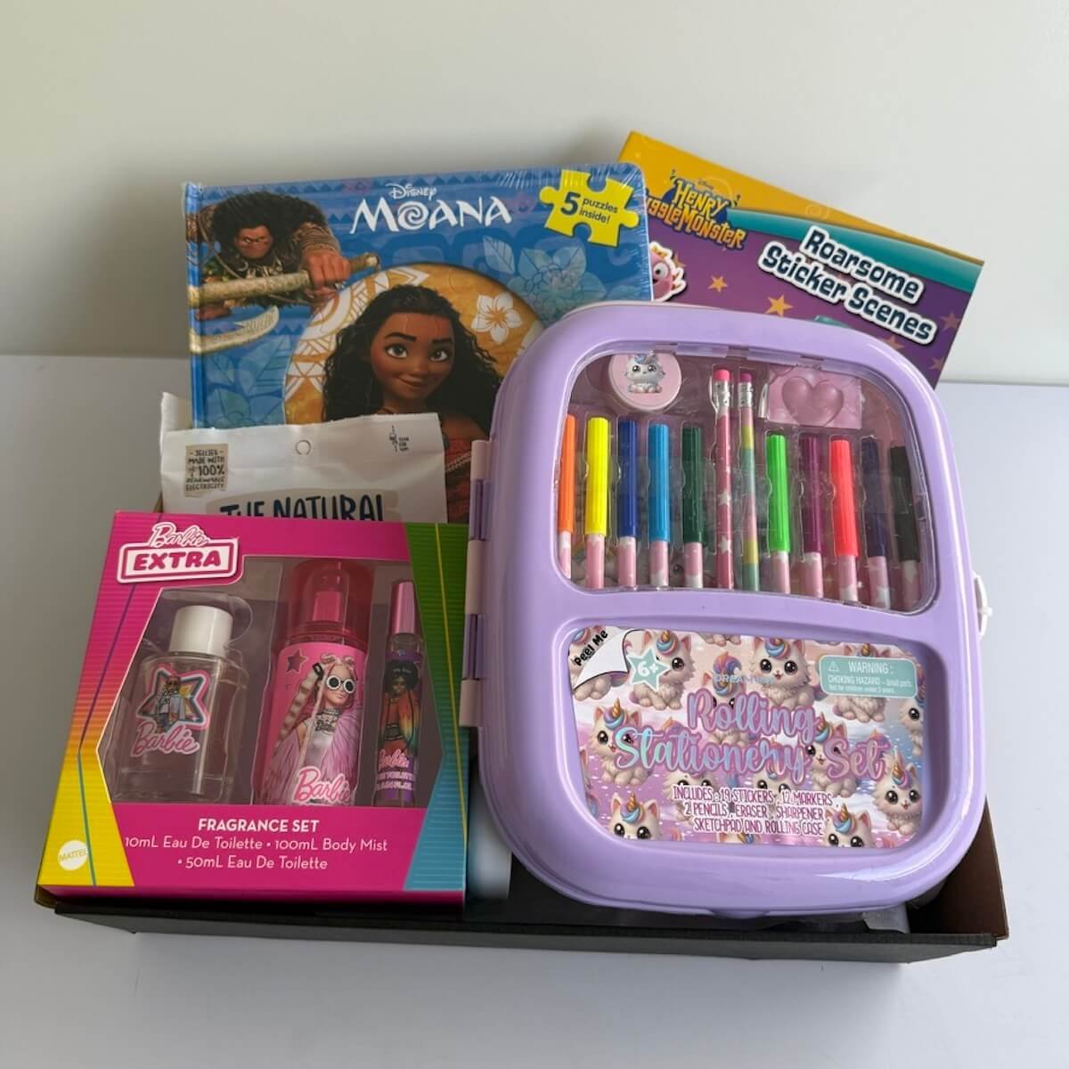Girls gift hamper with a stationery set, Barbie fragrance gift set, Disney Moana puzzle book, sticker book and snake lollies. Same-day Gold Coast delivery.