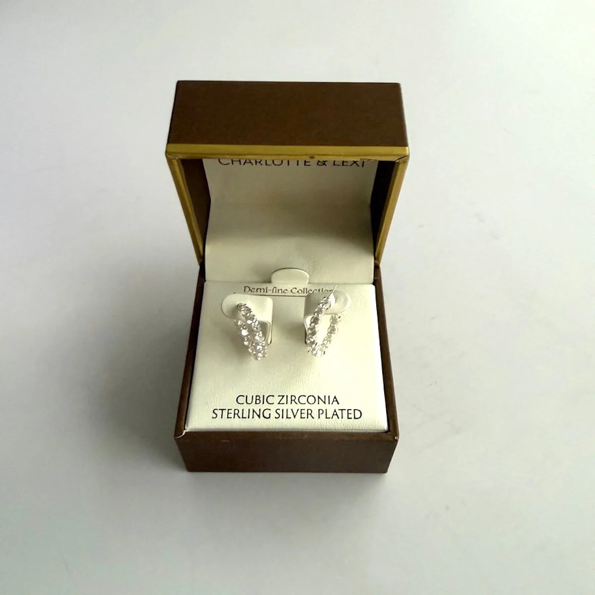 Cubic zirconia sterling silver plated hoop earrings presented in a luxury gift box.
