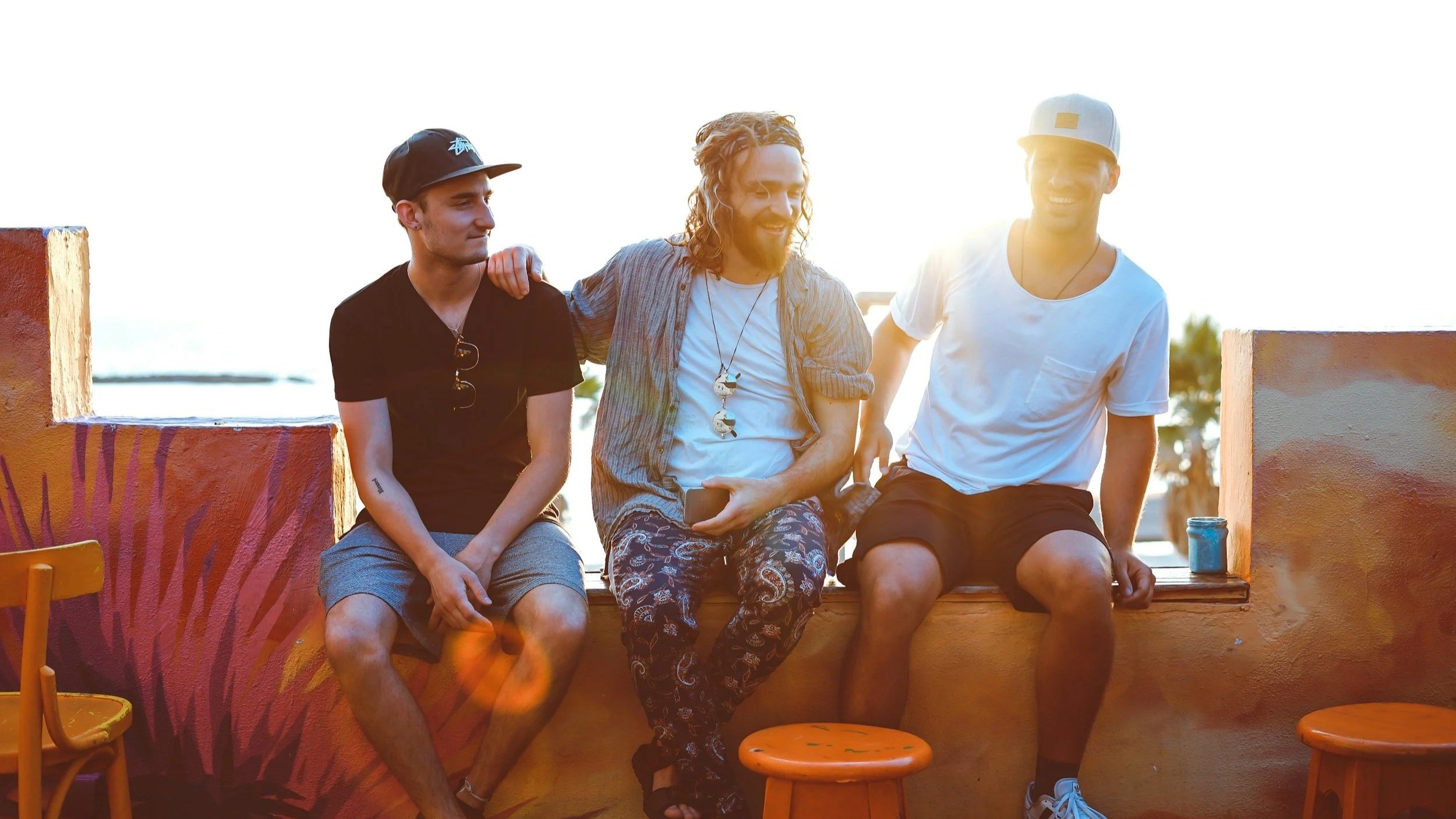 Three men sitting together enjoying beer, perfect for gifting on the Gold Coast