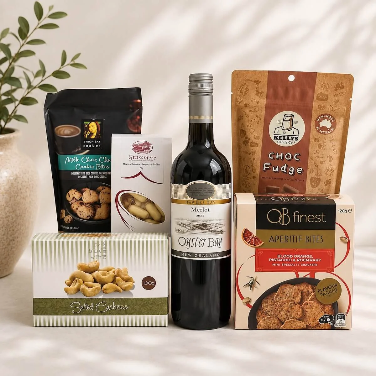 Gourmet Gift with a bottle of wine, chocolate coated Almonds, Chocolate Fudge, chocolate cookies, apertife crackers.