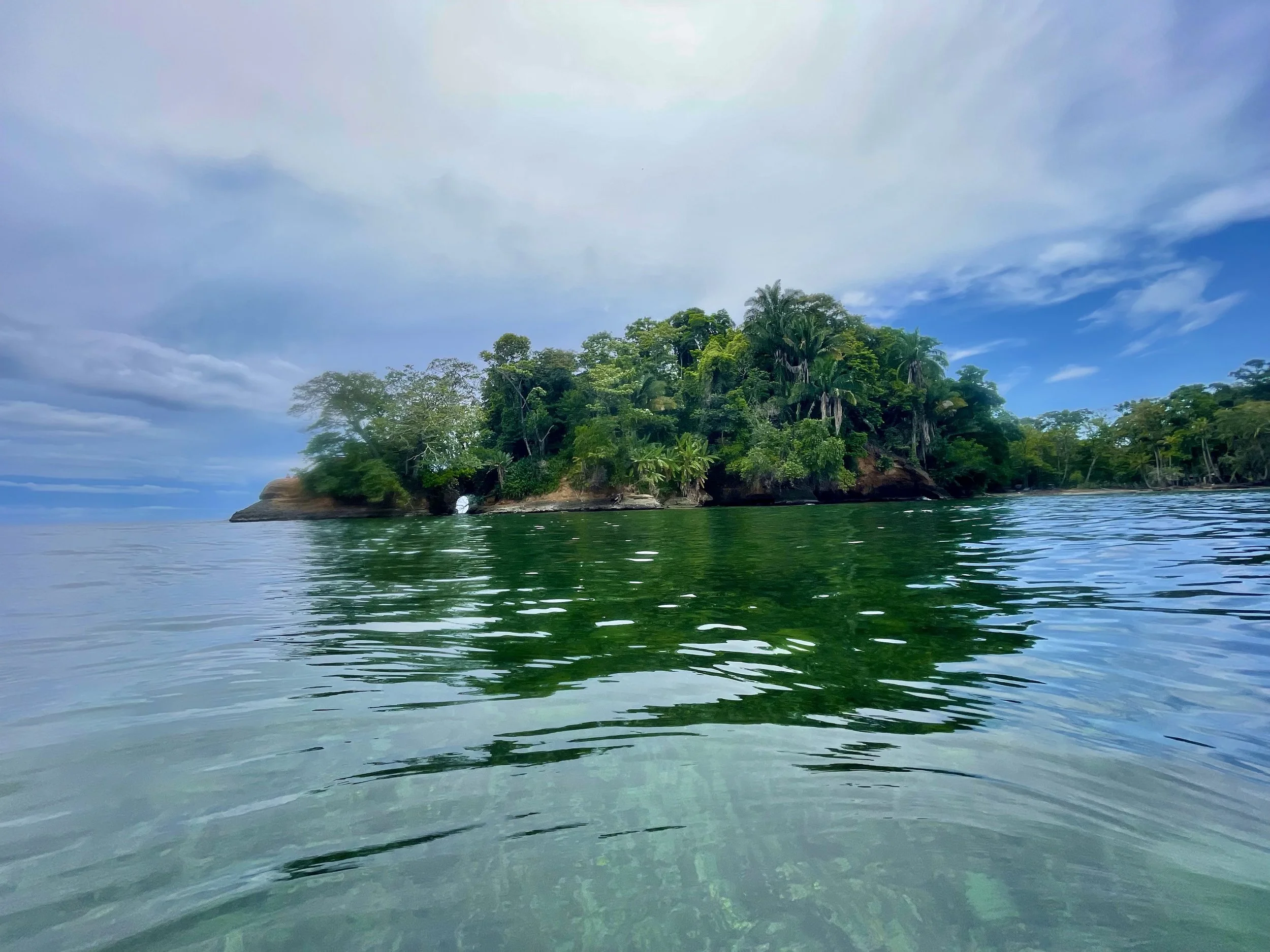 Tree lined point with key hole and turquoise ocean atPunta Uva Costa Rica