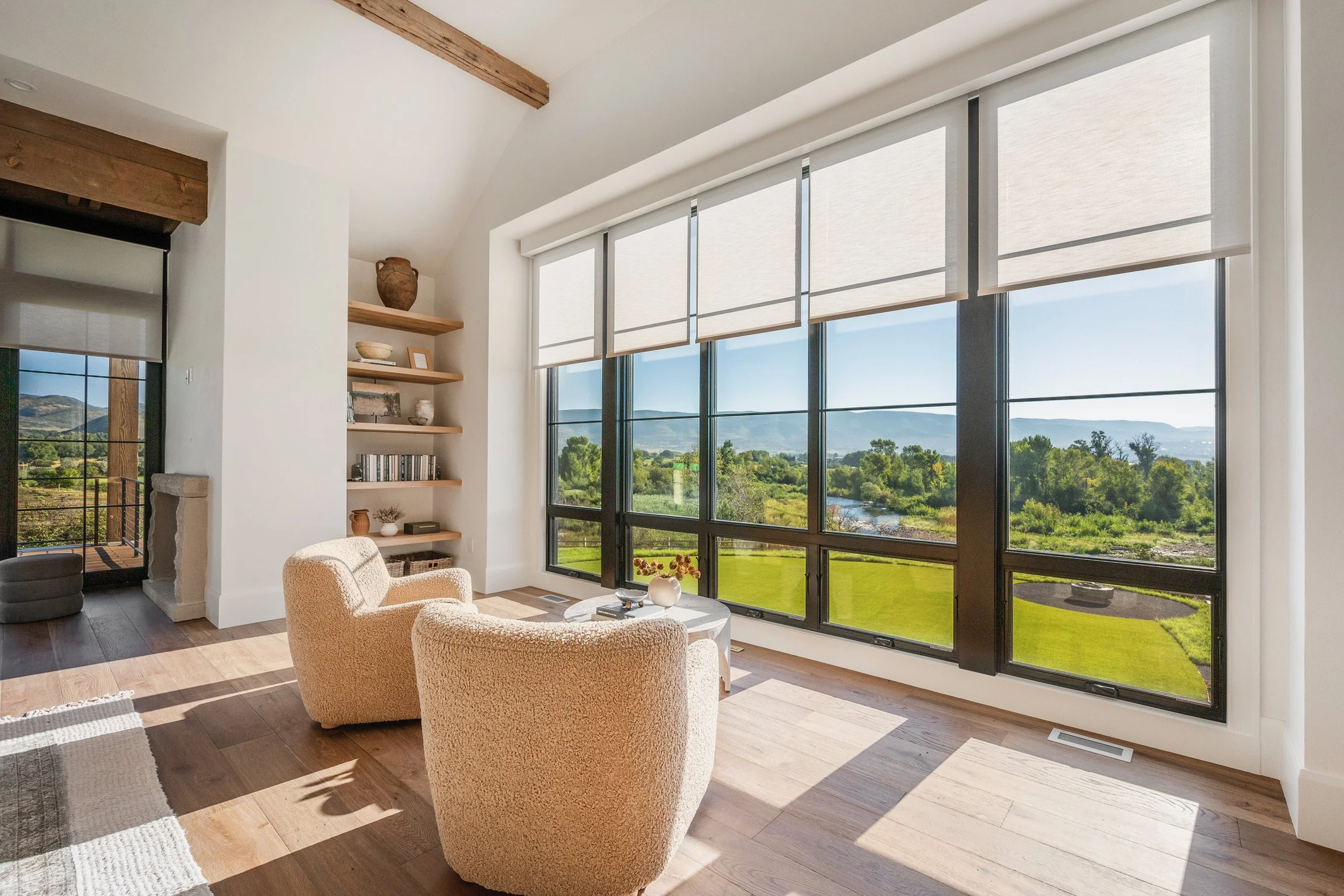 Hunter Douglas custom motorized shades installed in a luxury living room overlooking a Park City mountain valley.
