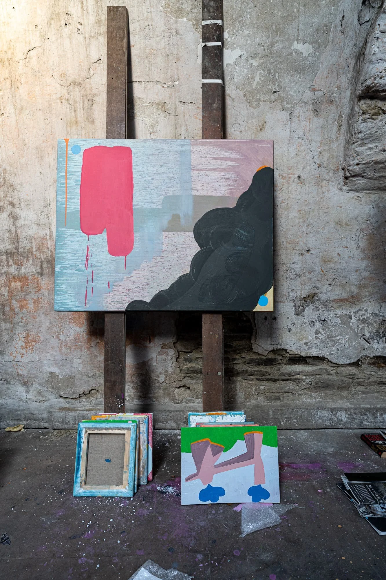 Abstract oil painting in progress on easel, blue grey pink and dark billowing forms, West Cork studio stone wall, Martin Finnin Irish artist