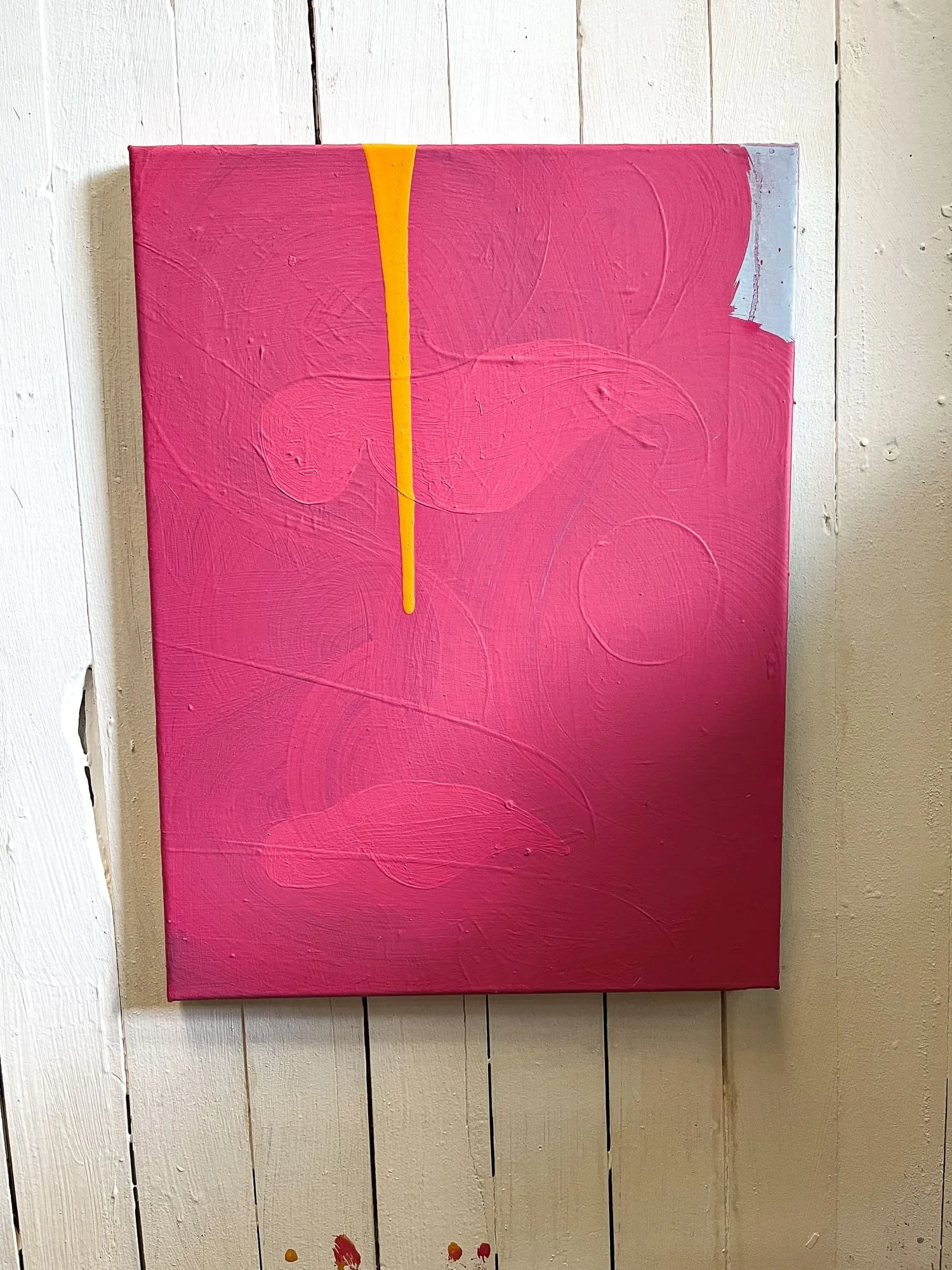 Early stage abstract oil painting on studio wall, vivid pink ground with orange drip and gestural marks, West Cork studio, Martin Finnin Irish artist