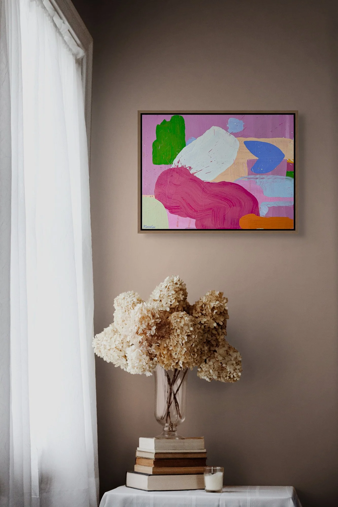 Colourful abstract oil painting on warm taupe wall above dried hydrangeas, pink green blue and white contemporary art, statement painting for calm elegant interior, Martin Finnin Irish artist