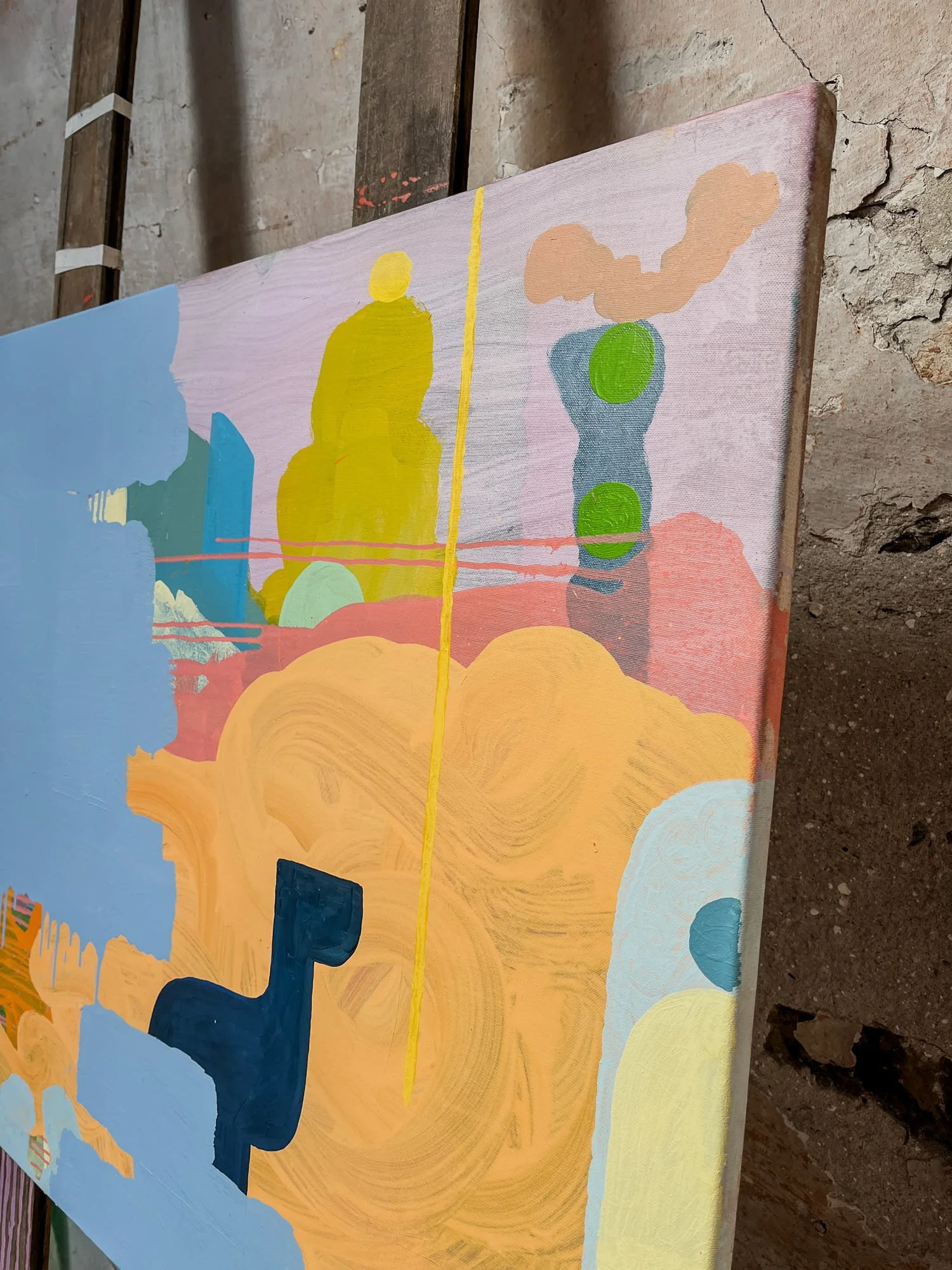 Close up of canvas edge showing layered oil paint surface, peach orange yellow and blue abstract forms with swirling texture, original painting detail by Martin Finnin West Cork studio