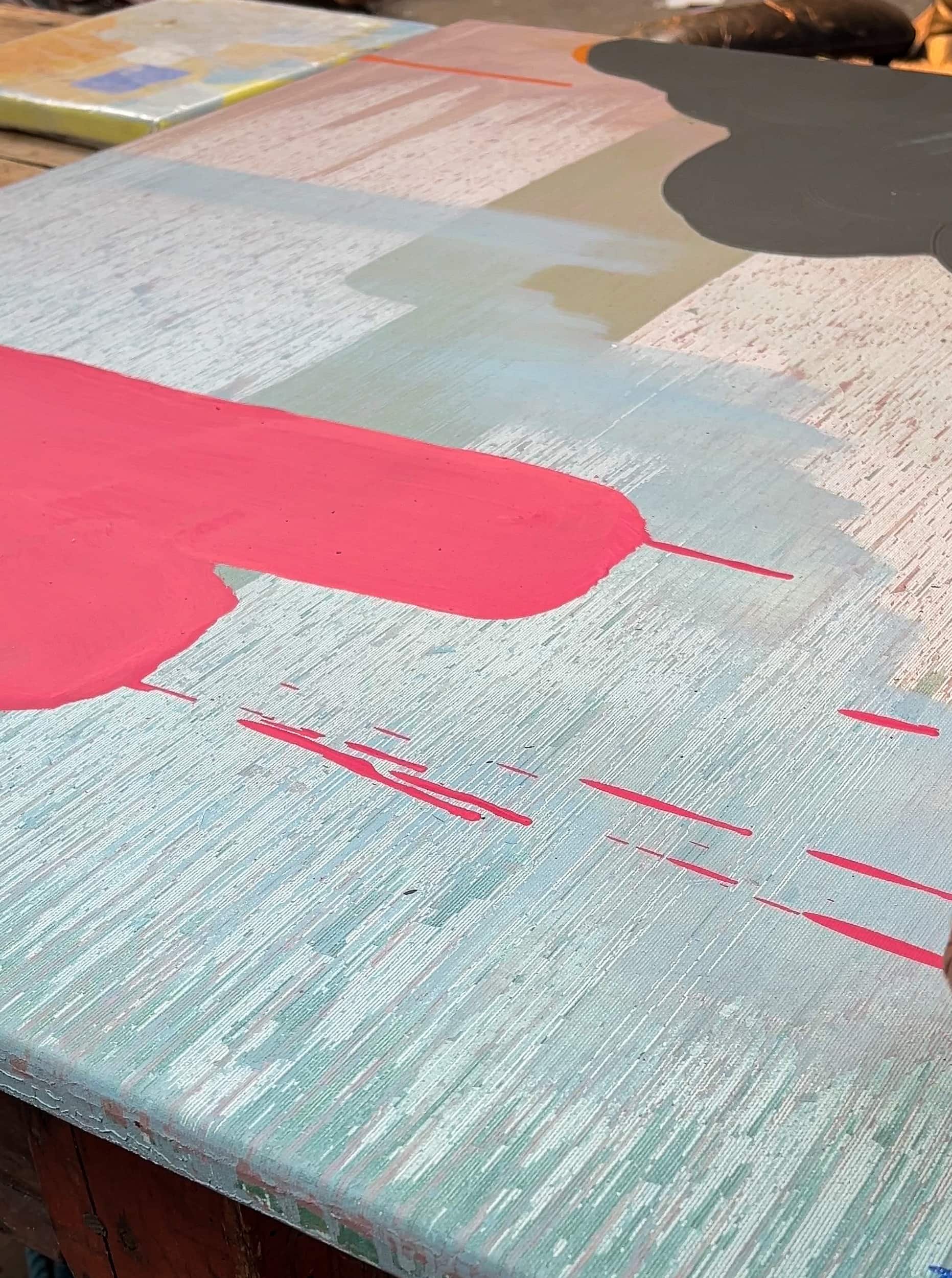 Close up of canvas edge showing layered oil paint surface, bold pink form with drips on pale blue silk like textured canvas, painted edge depth in West Cork studio, Martin Finnin Irish artist