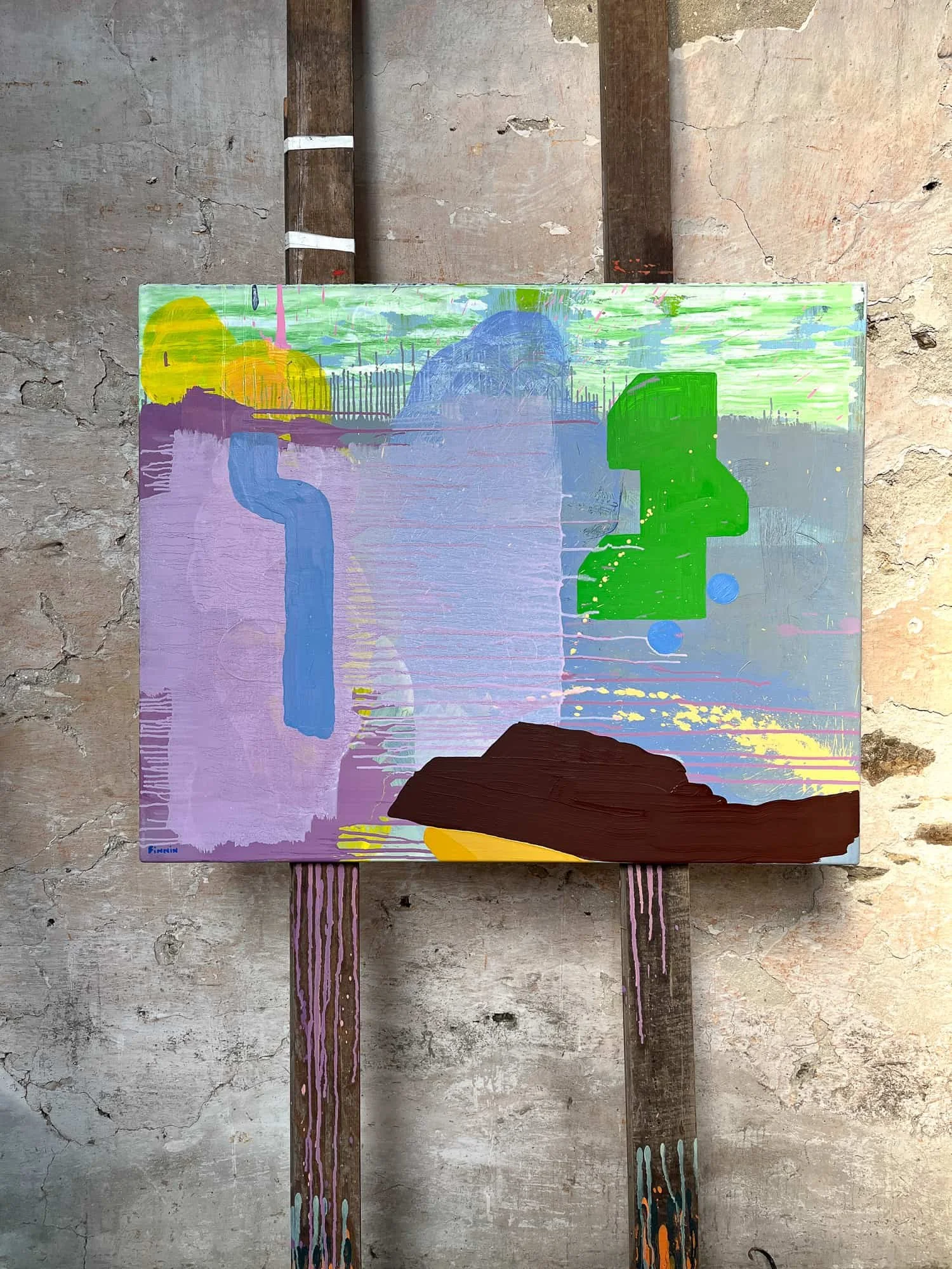 Abstract oil painting on easel in raw stone West Cork studio with warm side light, lavender pink green and brown canvas, original oil painting by Irish artist Martin Finnin