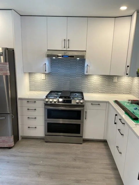 Modern kitchen renovation finished with high quality cabinetry, quart counters, and new appliances.