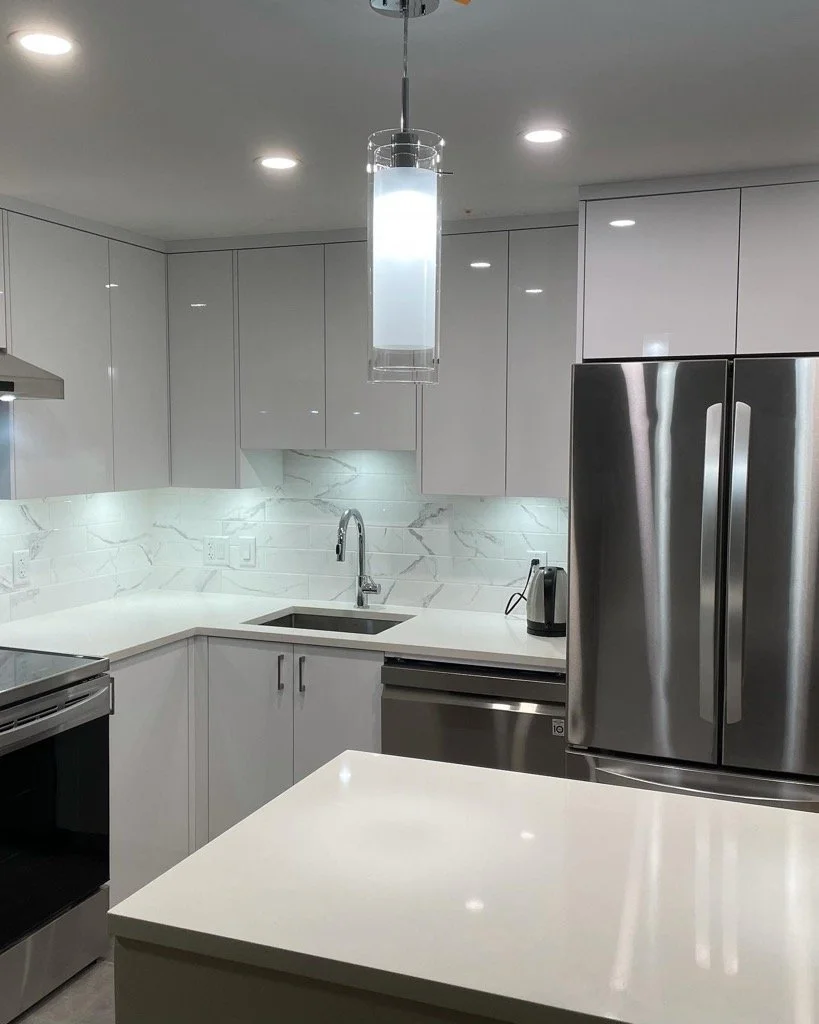 Modern kitchen renovation finished with high quality cabinetry, quart counters, and new appliances.
