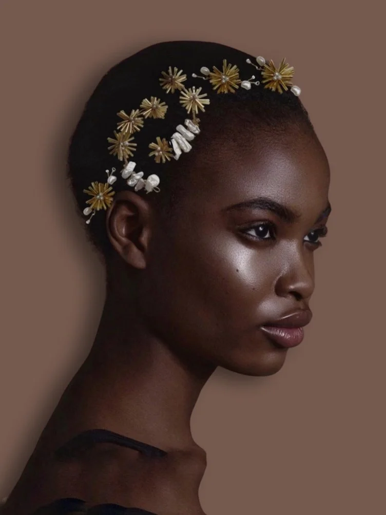 Woman with decorative hair accessory, brown background