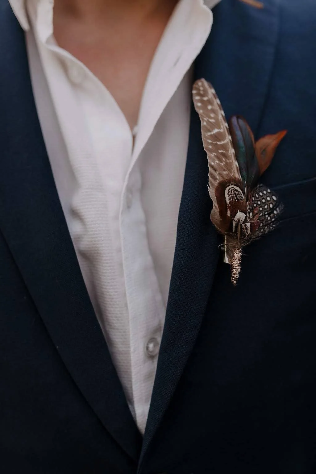 feather boutinniere for groom maria sarinana.jpeg
