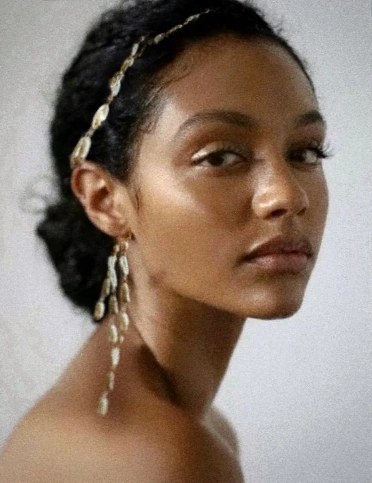 Woman with braided hair and dangling earrings