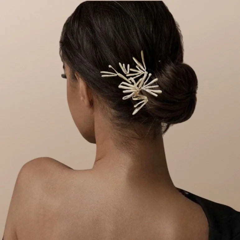 Woman with hair bun and decorative hairpin