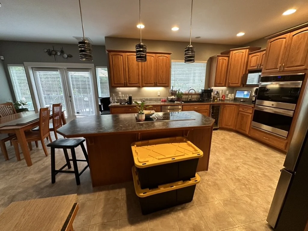Modern kitchen with wooden cabinets, island, and dining area
