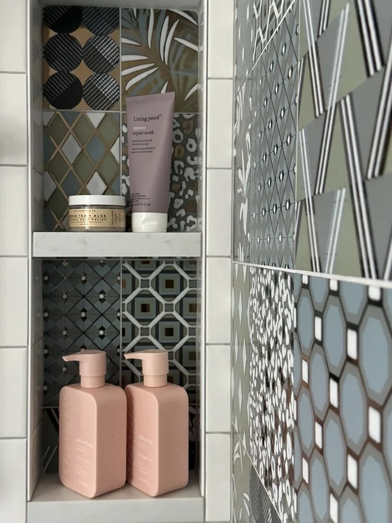 Colorful tiled shower niche with hair and skin products.