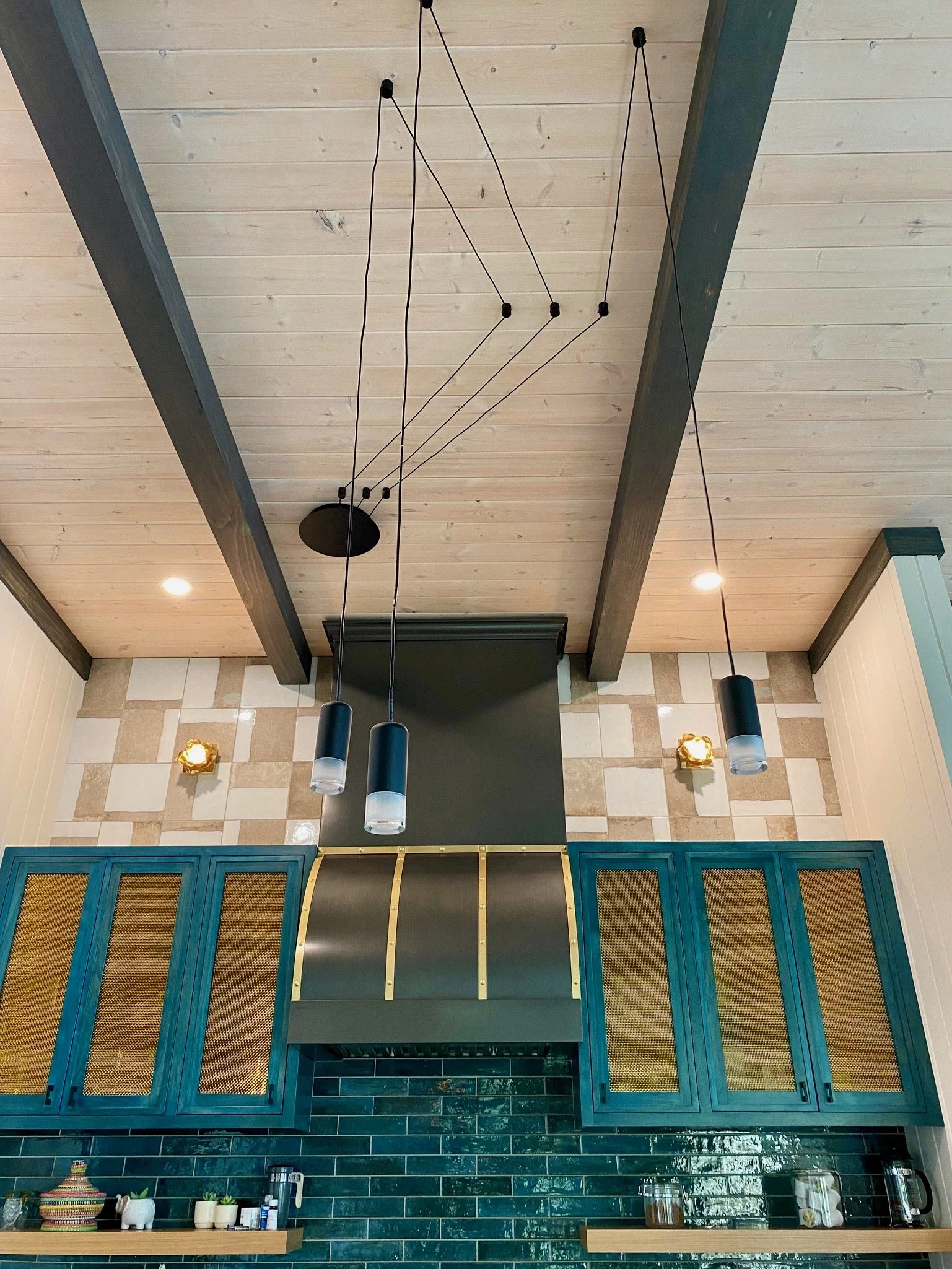 Modern kitchen interior with blue cabinets and unique ceiling lighting