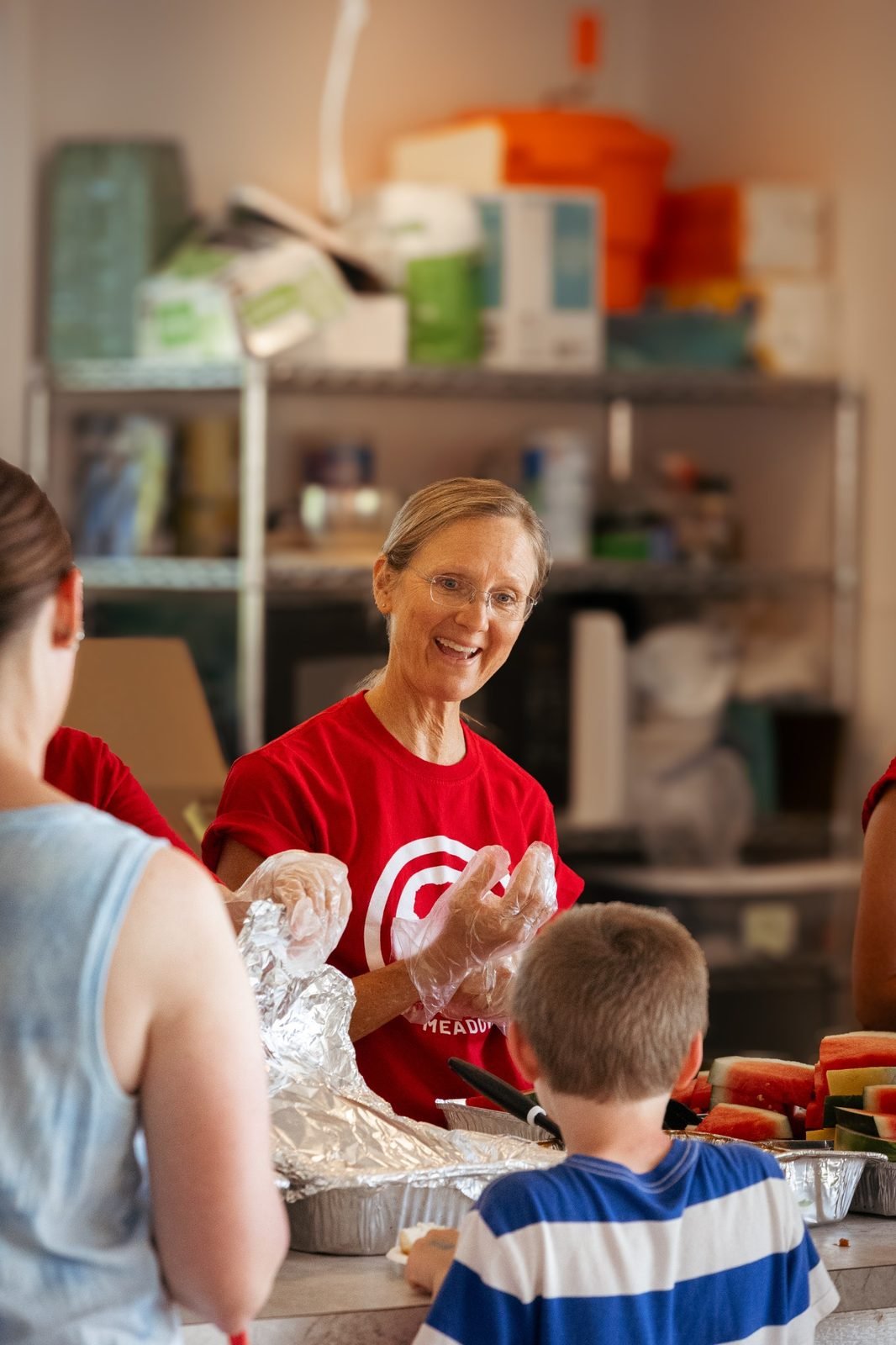 joy-meadows-second-saturday-june-2026-volunteer-serving-food.jpg
