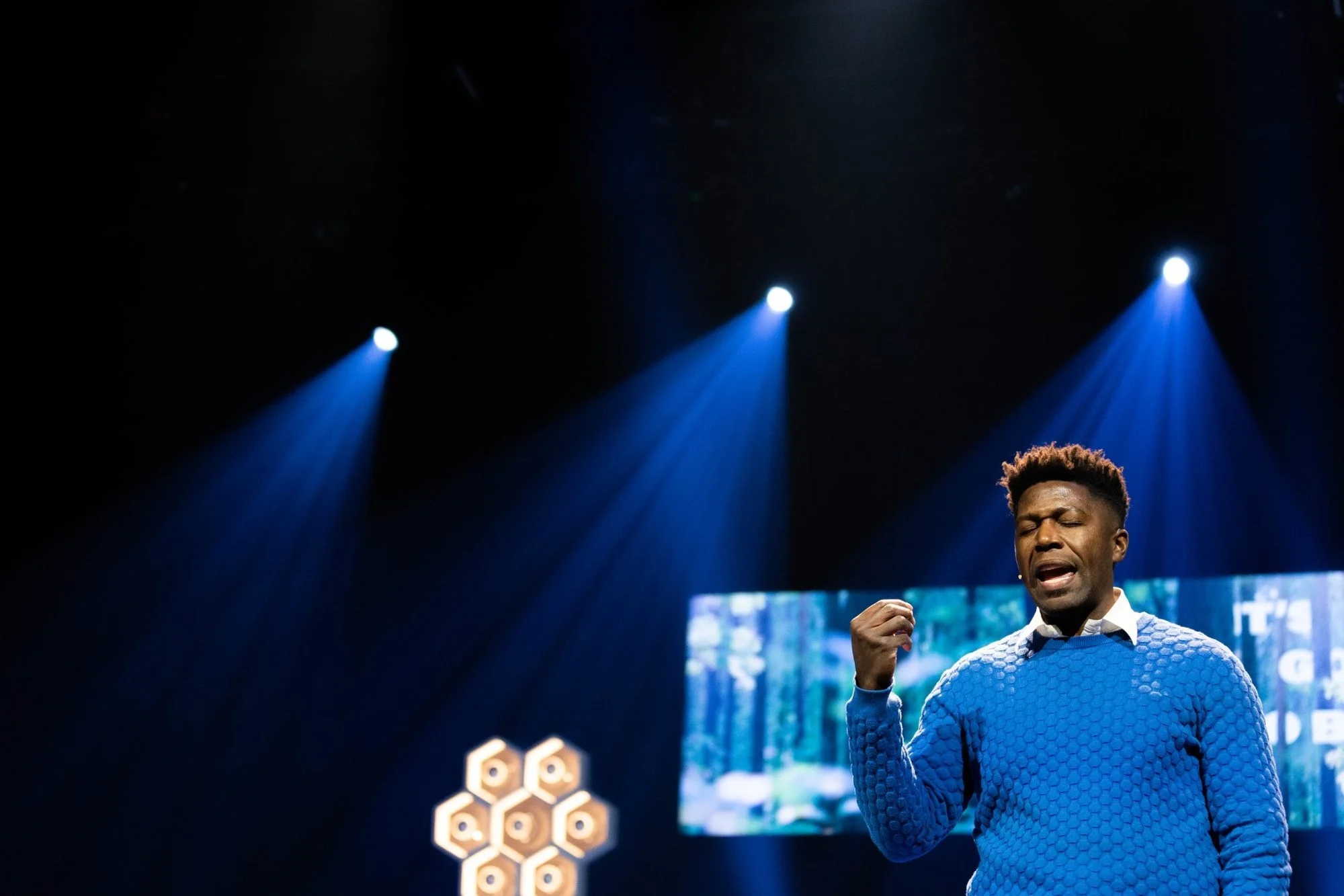 re-conference-speaker-blue-sweater-stage.jpg