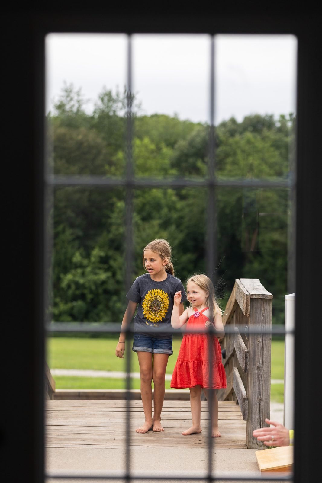 smail-family-reunion-2026-two-girls-through-window.jpg