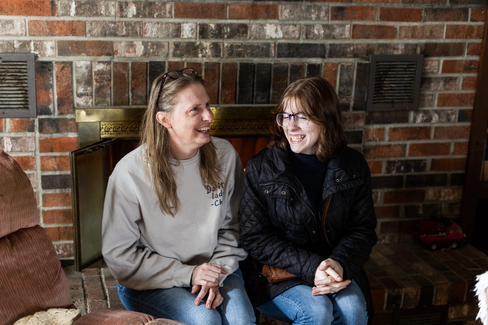 rural-missouri-family-dinner-women-laughing-by-fireplace.jpg