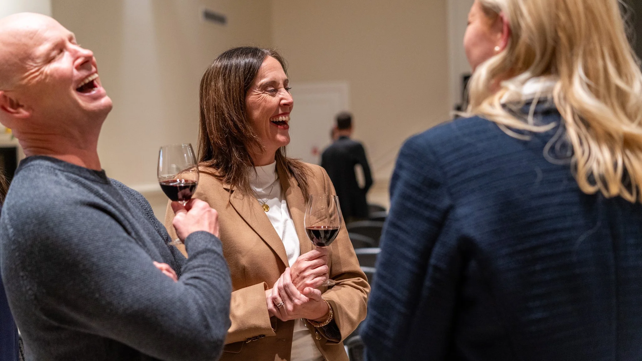 Napa Valley book tour gallery: guests laughing together at a wine reception