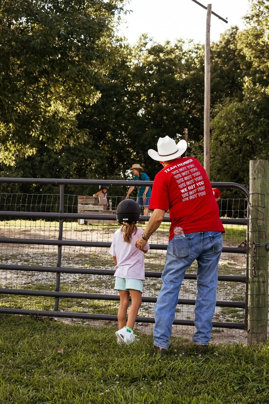 joy-meadows-second-saturday-july-2026-volunteer-and-child-at-fence.jpg