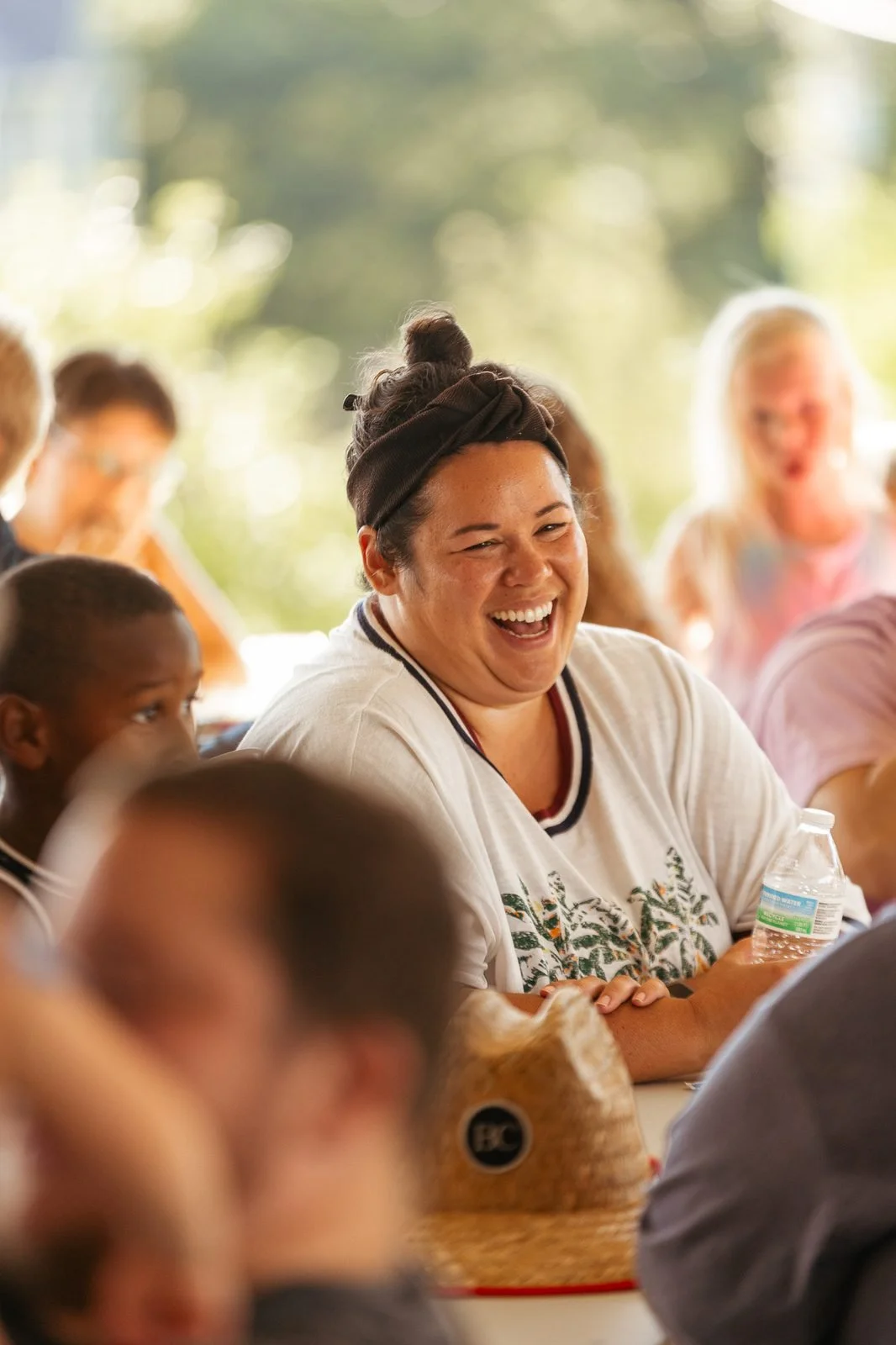 joy-meadows-second-saturday-july-2026-woman-laughing-at-picnic-table.jpg