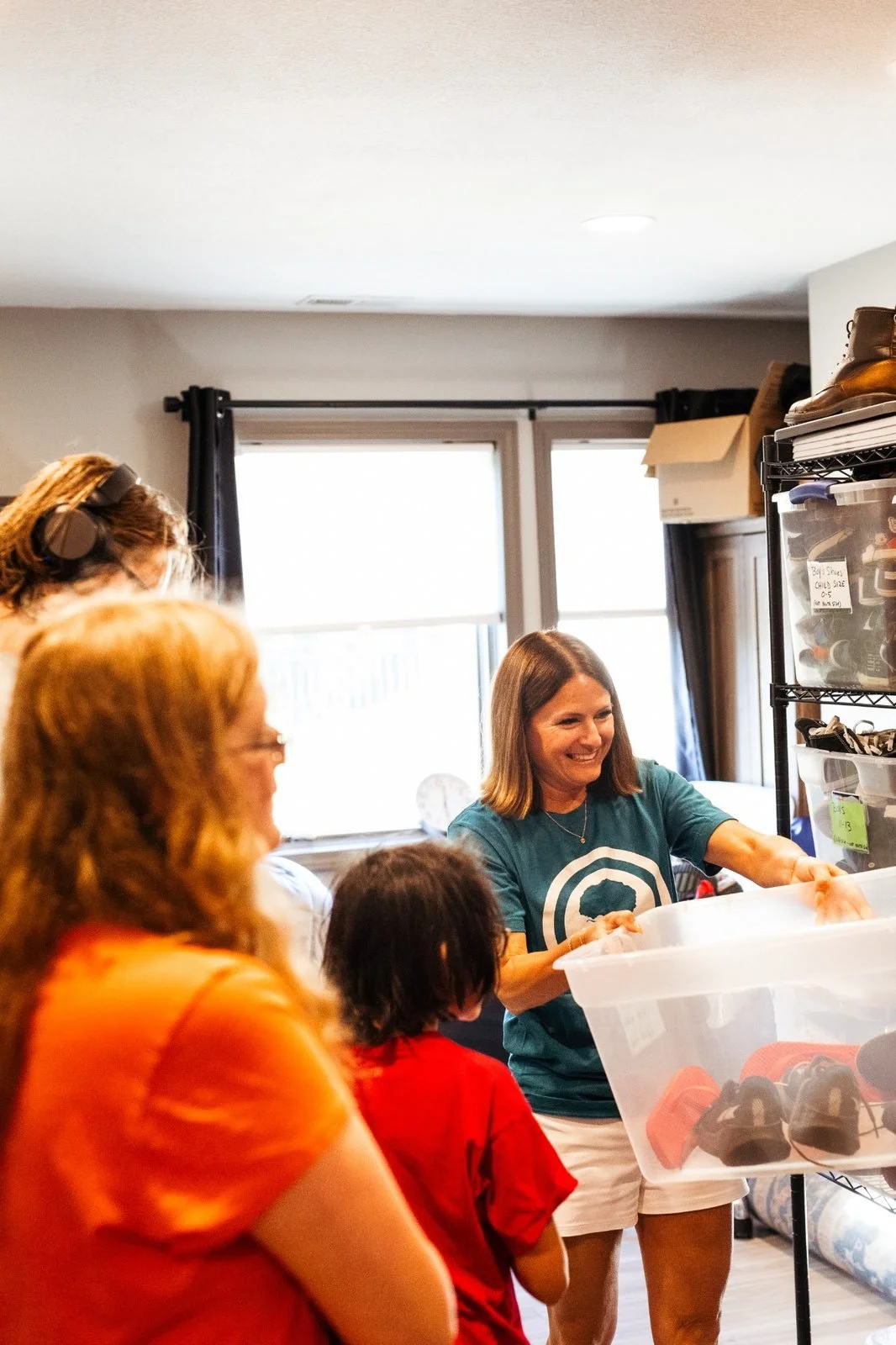 joy-meadows-second-saturday-june-2026-volunteer-organizing-shoes.jpg