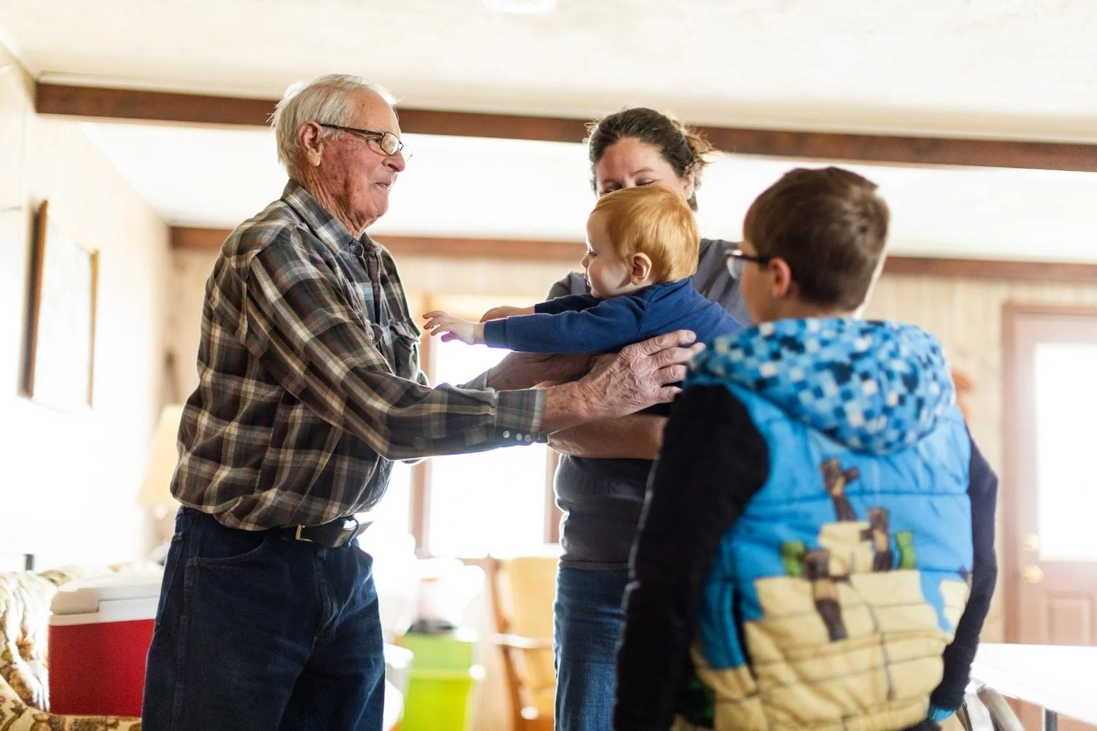 rural-missouri-family-dinner-older-man-greeting-baby.jpg