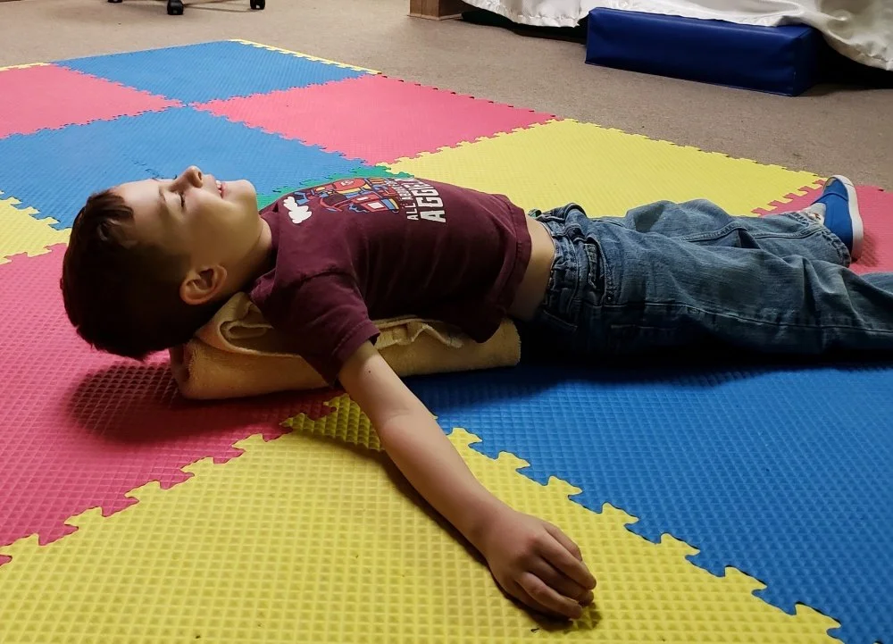 With towel roll along spine, bring arms up to shoulder level until you feel stretch across chest. Hold this position. If there is pain, stop the exercise. Hold position for 30seconds, complete 3 sets. Repeat 2x/day. Take breaks as needed.